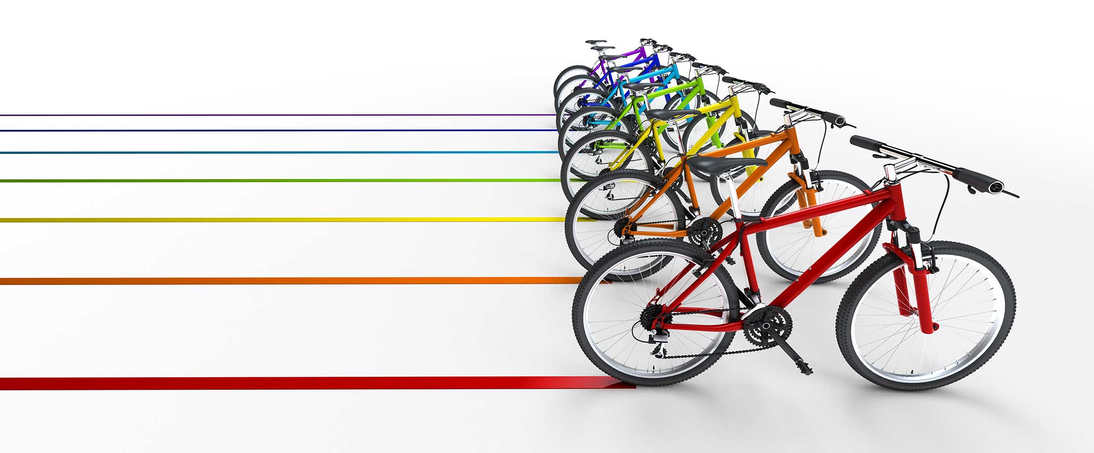 Fahrrad- & E-Bike-Versicherung Bunte Fahrräder fahren vor einem weißen Hintergrund und ziehen Spuren in der gleichen Farbe nach sich.